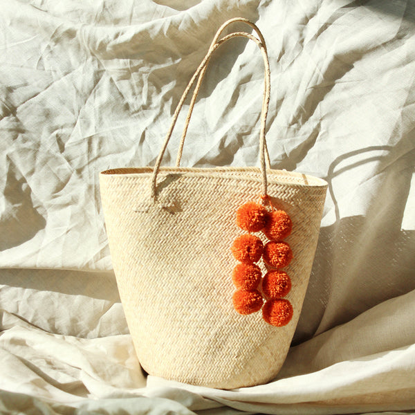 Borneo Serena Straw Tote Bag with Pumpkin Orange Pom-poms by BrunnaCo